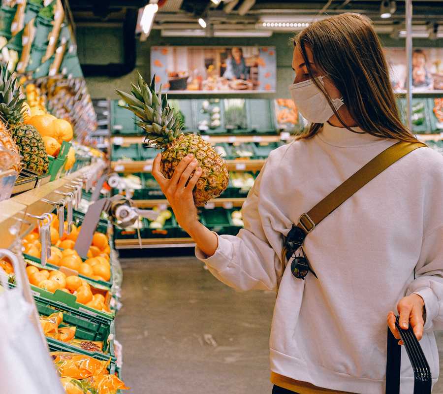 Woman in supermarket wearing mask
