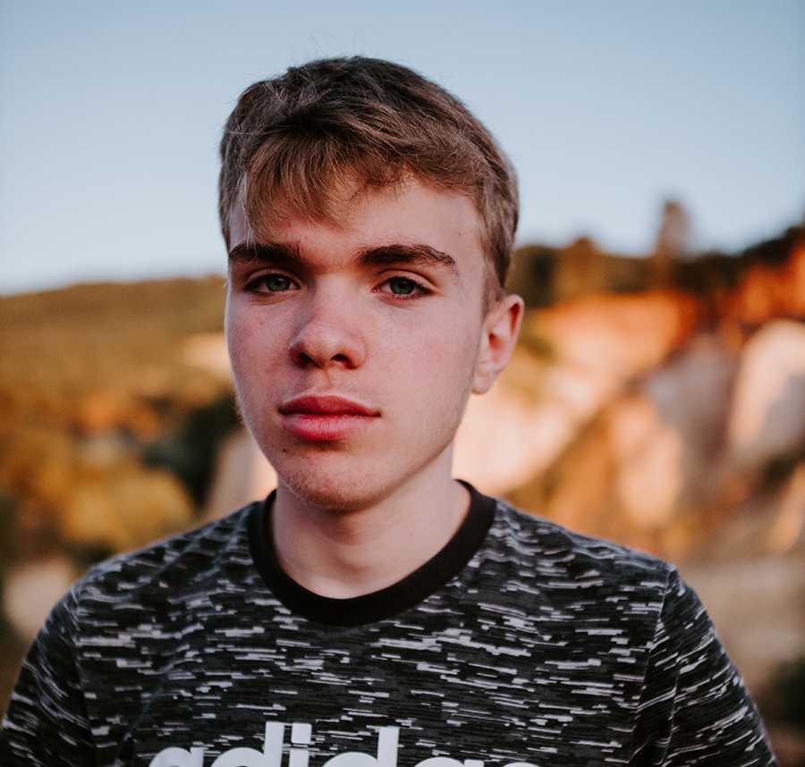 A young white boy stares at the camera