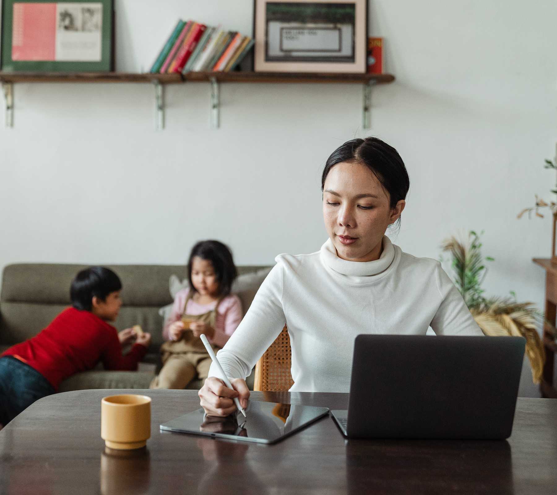 Woman working at home with children