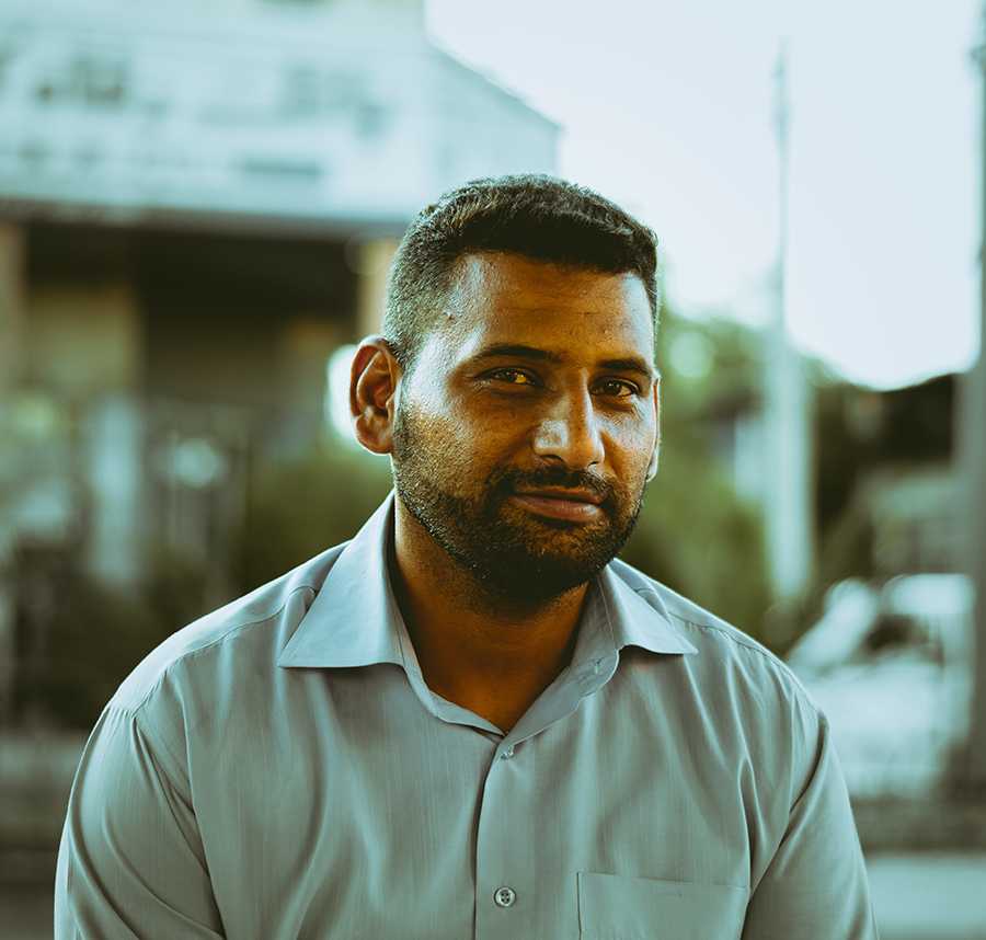 An Iranian-Australian man smiles at the camera